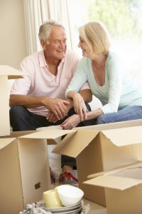 42400799 - senior couple moving home and packing boxes